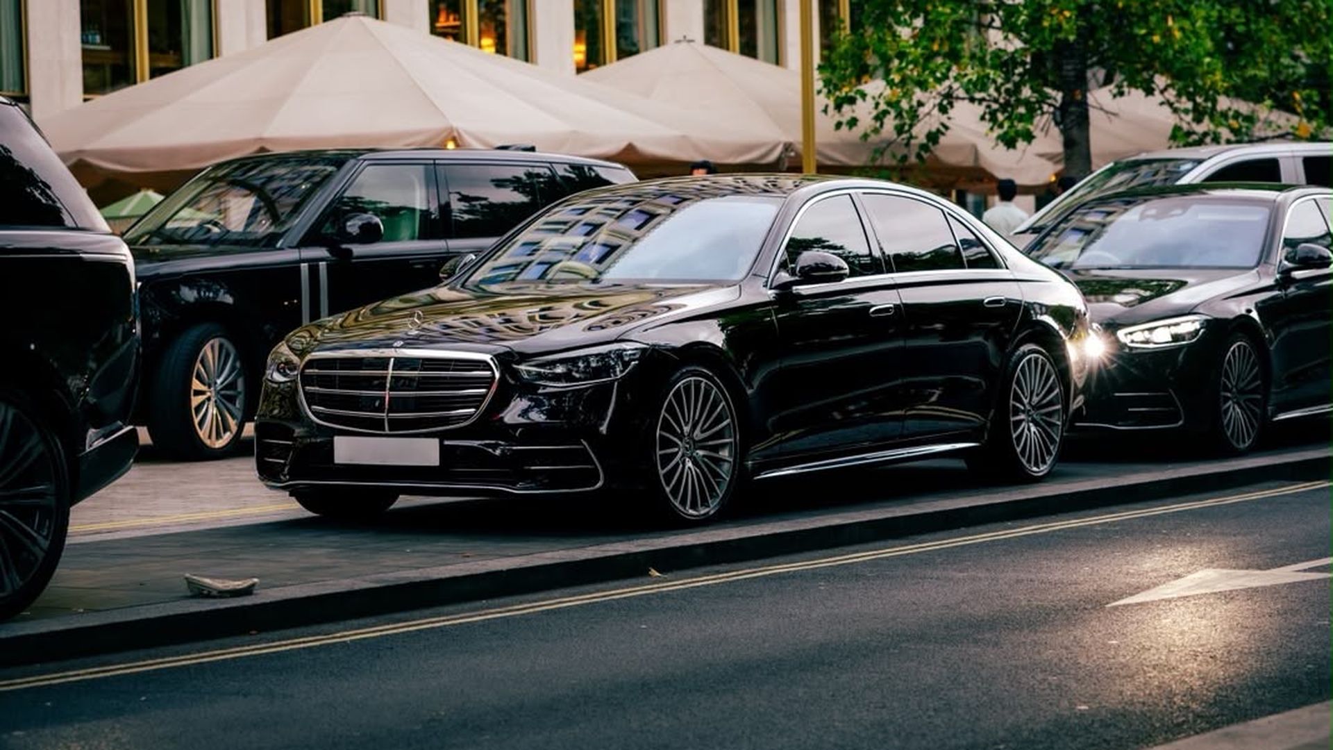Black Mercedes-Benz S-Class chauffeur car outside a corporate building in London