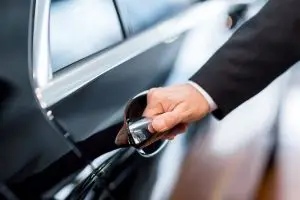 Chauffeur opening the door of a luxury car during an hourly chauffeur booking in London