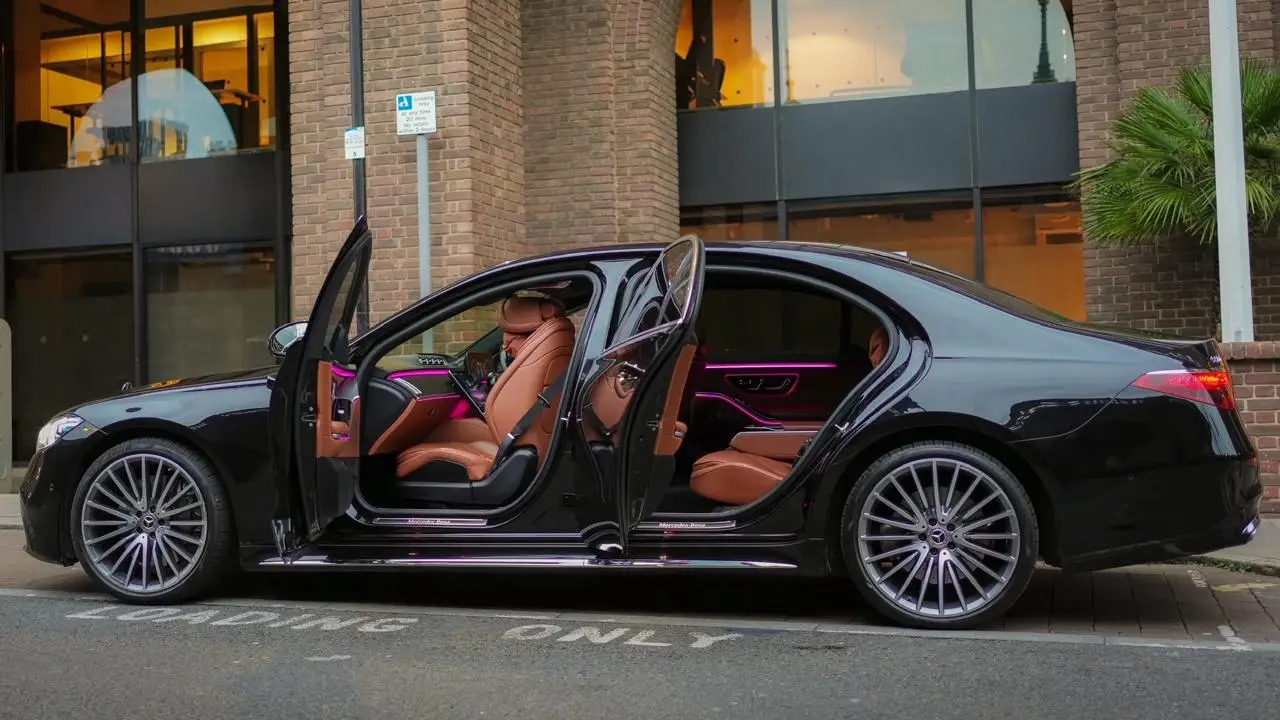 Black Mercedes S-Class with doors open, chauffeur hire London