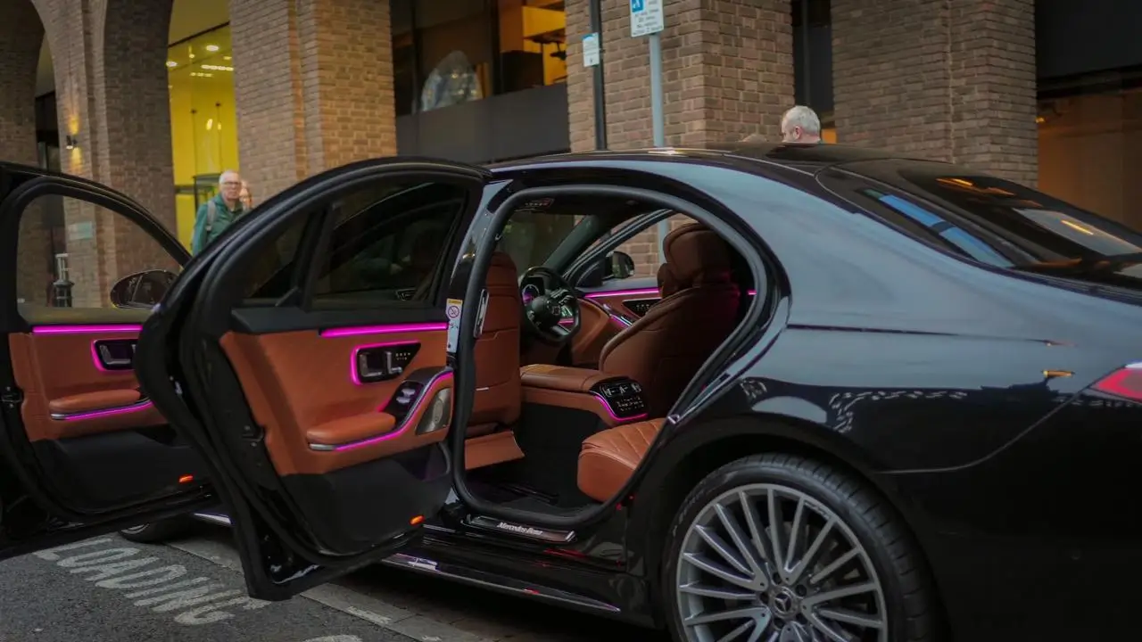 Black Mercedes S-Class chauffeur pick-up on a London street