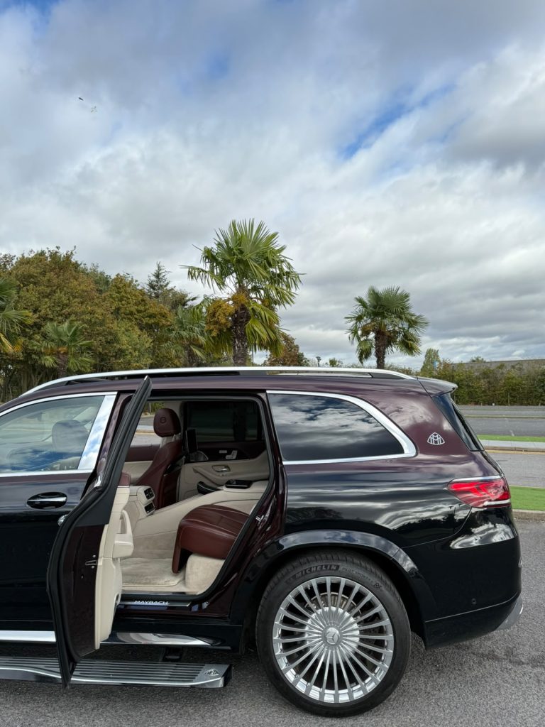 Side profile of the Heylux Mercedes-Maybach GLS 600 in two-tone black and burgundy with the rear door open