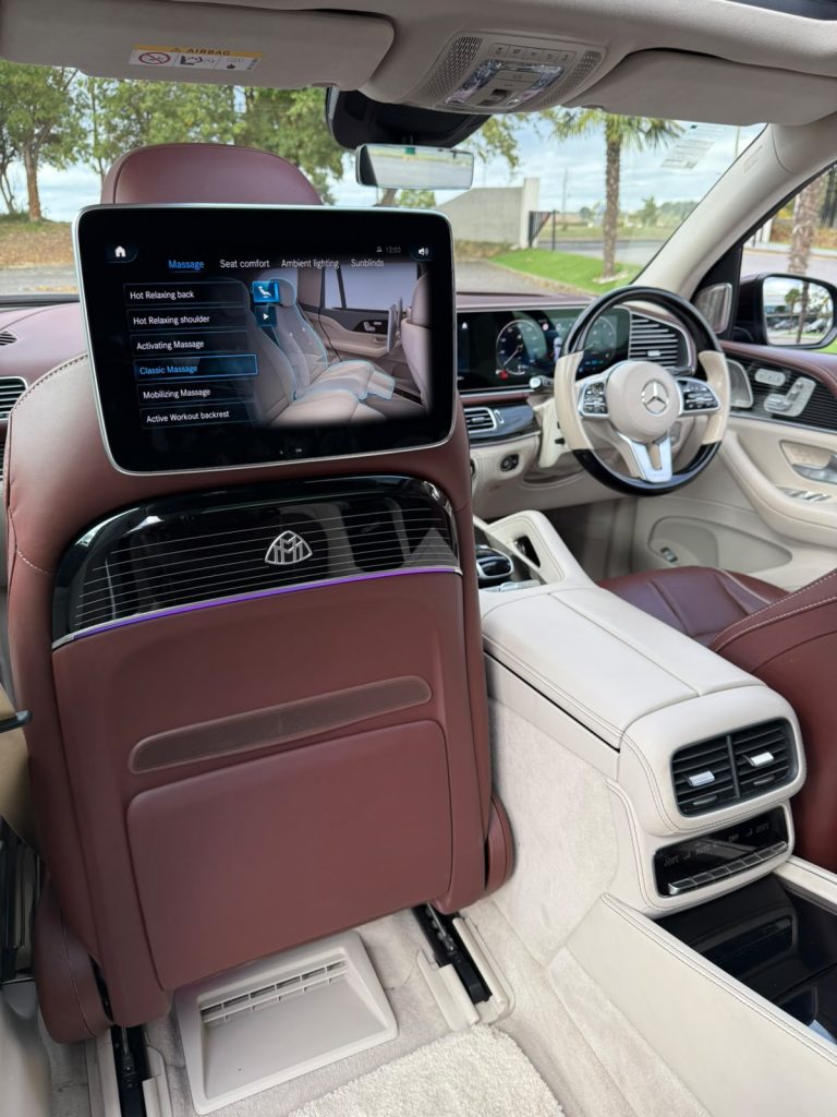Rear seat-back screen in the Maybach GLS showing massage, seat comfort, ambient lighting and sunblind controls